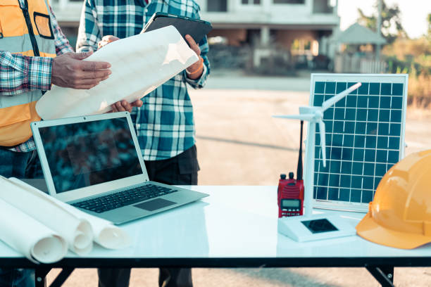 istock Meeting with engineers about wind turbine models and house models. Concepts for housing development and renewable energy The team wore safety gear. Talk about installation plans Check the working system solar panel 2185251815