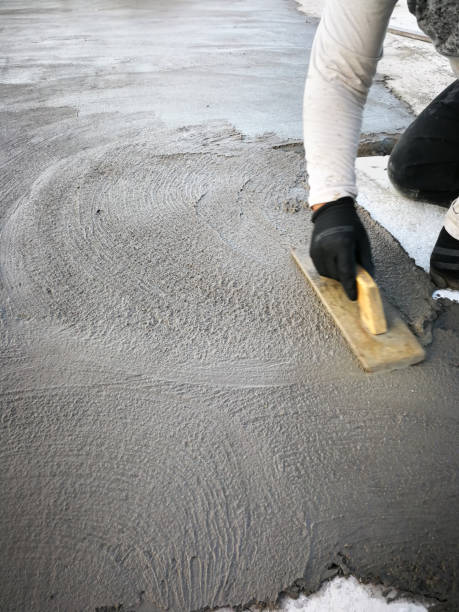 istock Bricklayer smoothes out fresh cement with a trowel. 2185251997