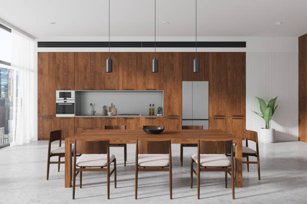 istock Wooden home kitchen interior with dining table and cabinet, panoramic window 2185252528