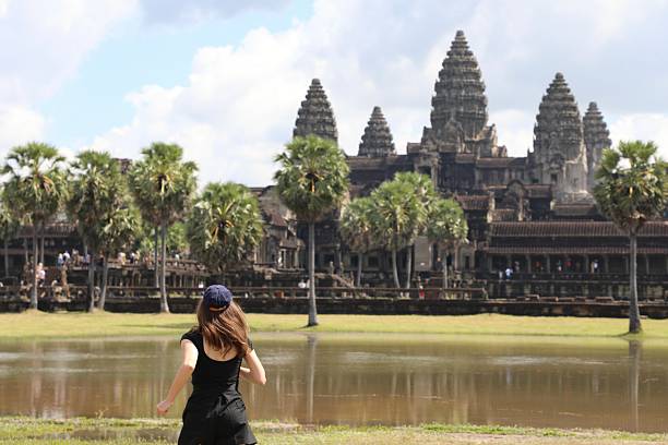 A girl tourist in traditional dress in the Angkor Wat temple - Cambodia