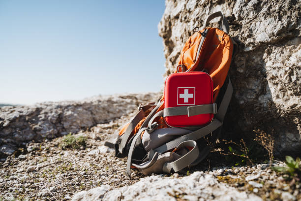 istock A first aid kit is placed on top of an orangecolored backpack 2185255083