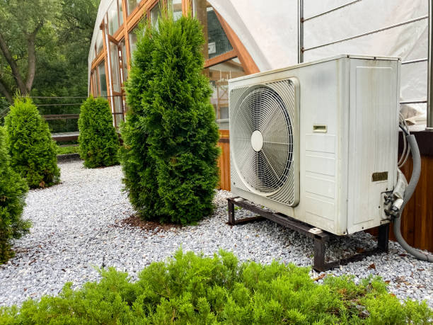 istock A modern air conditioning unit is beautifully nestled amidst vibrant, lush greenery, enhancing the residential landscape and environment 2185255151