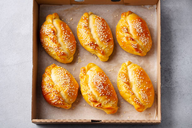 Sweet or savoury pies in a box. Grey background. Close up. Top view.