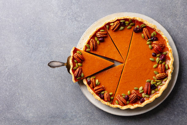 istock Pumpkin pie on a white plate. Grey background. Close up. Top view. 2185256310
