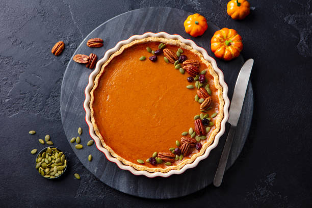 istock Pumpkin pie, tart in baking dish. Black background. Top view. 2185256725