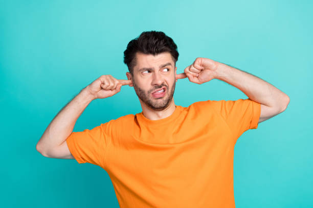 istock Photo of young attractive handsome unhappy man put finger ears look empty space pouted lips tongue impressed isolated on aquamarine color background 2185257879
