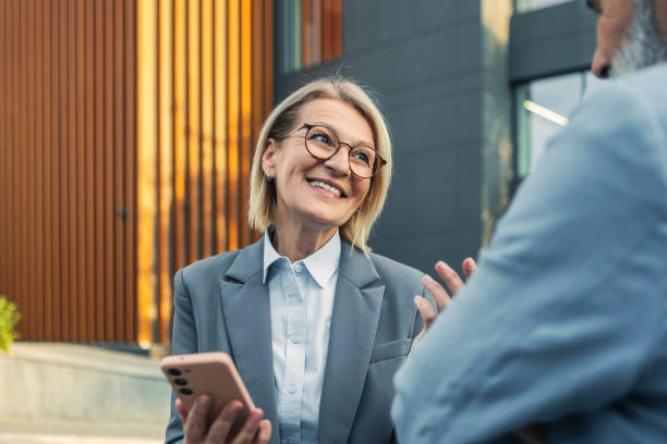 istock Smartphone in Hand During Outdoor Chat 2185259309
