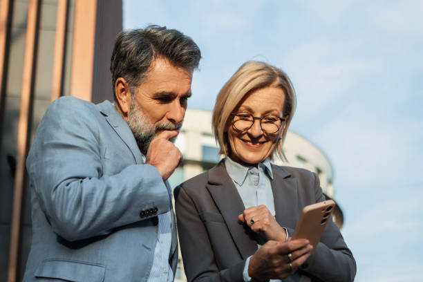 istock Business Partners Engaged with Smartphone 2185259321