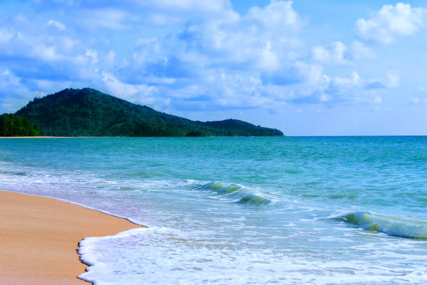 Light blue sea waves and island on clean sandy beach, Tropical white sand beach and soft sunshine background