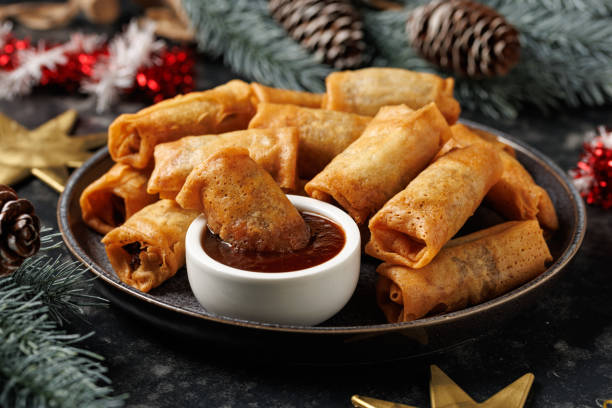 istock Christmas duck spring rolls with decoration, gifts, green tree branch 2185263614