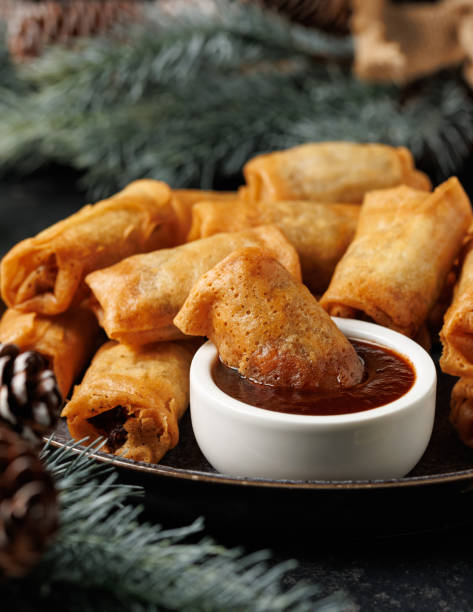 istock Christmas duck spring rolls with decoration, gifts, green tree branch 2185263621