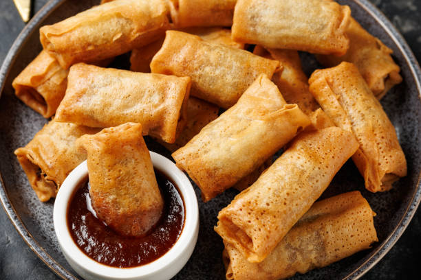 istock Christmas duck spring rolls with decoration, gifts, green tree branch 2185263644