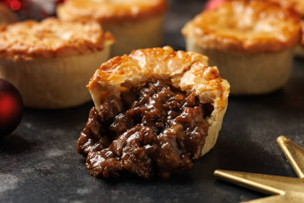 istock Christmas steak mini pie with decoration, gifts, green tree branch 2185263657