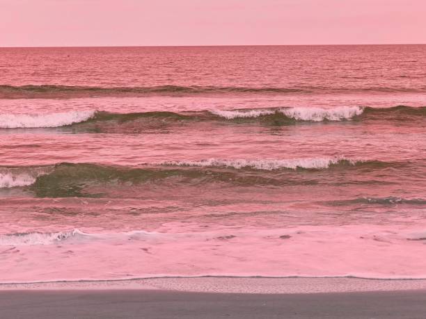 istock Warm red light shimmers over the breaking waves of the Atlantic ocean 2185263674