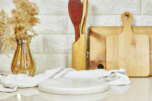 istock Kitchen brass utensils, chef accessories. wood tabletop with white marble board with napkin 2185264124