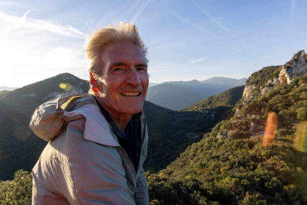 istock Portrait of mature man on mountain above lush valley 2185264792