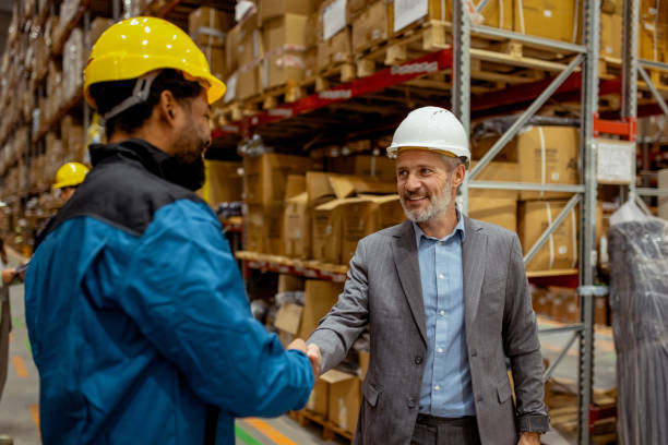 istock Warehouse Owner and Employee Shaking Hands After Positive Meeting 2185268948
