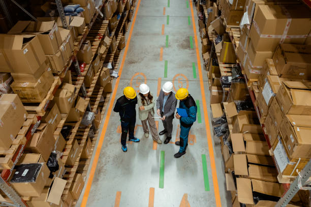 istock Captured From Above: Two Warehouse Manager Speaking With Workers in Busy Warehouse 2185269236