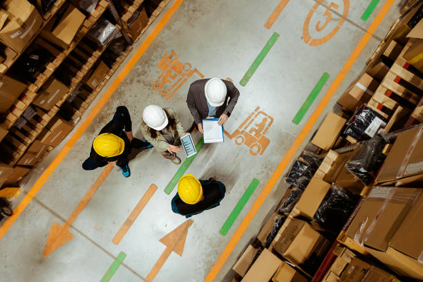 istock Captured From Above: Two Warehouse Manager Speaking With Workers in Busy Warehouse 2185269270