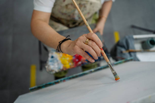 istock Artist starts painting on canvas at art workshop 2185271822