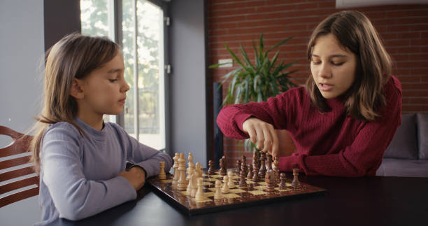 istock Two Child Girls Playing Chess Together 2185272909