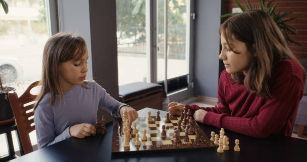istock Two Child Girls Playing Chess Together 2185273111