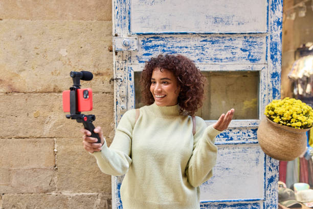 istock Influencer filming vlog with smartphone gimbal and microphone 2185273868