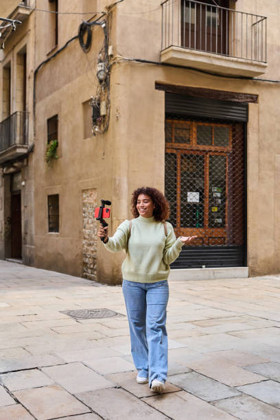 istock Influencer walking and filming vlog in barcelona's gothic quarter 2185274049