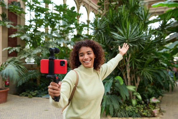 istock Young influencer filming vlog in botanical garden 2185274398