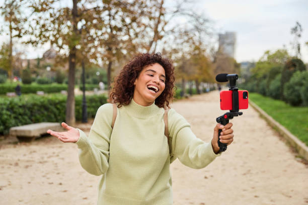 istock Young influencer filming vlog in a park using smartphone gimbal 2185274468