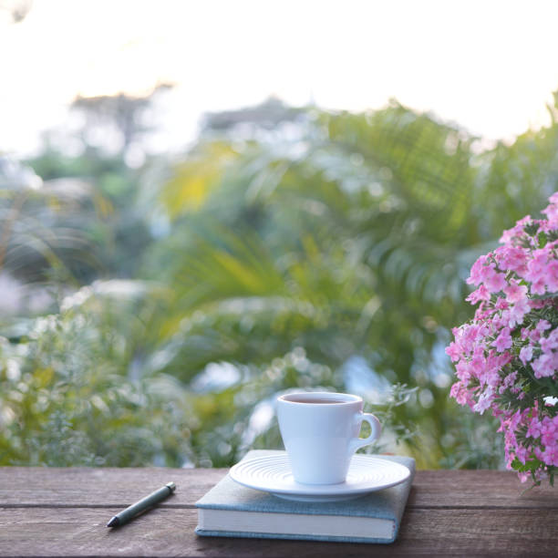 istock A White tea cup with Verbena flower and notebook, outdoor working 2185275501