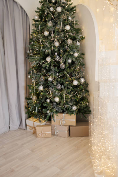 istock A large Christmas tree with many ornaments sits in front of a window 2185276296