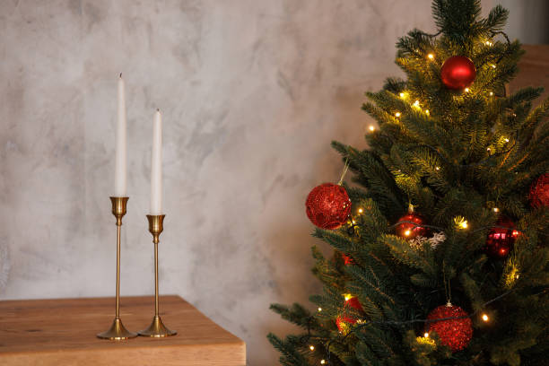 istock A Christmas tree with red balls and a pair of candles on a table 2185277031