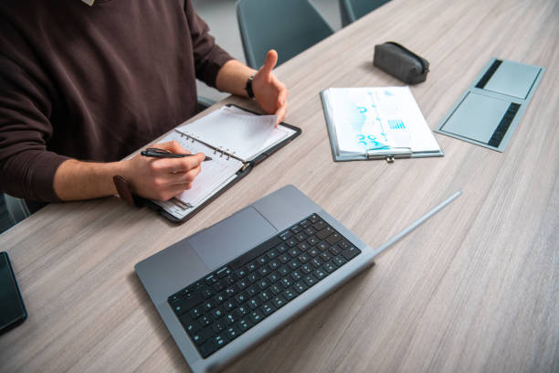istock Focused Young Caucasian Businessman Working at Office Desk 2185277054