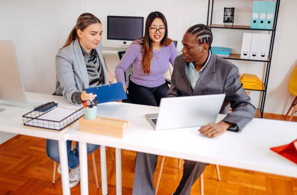 istock Small group of employees working together in front of computer 2185277668