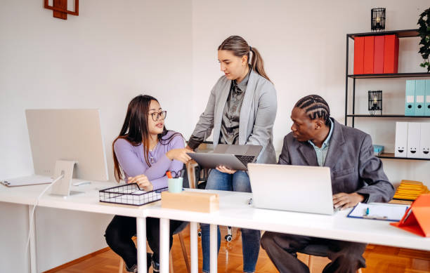 istock Small group of employees working together in front of computer 2185277705