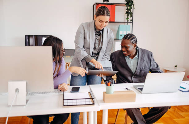 istock Small group of employees working together in front of computer 2185277713