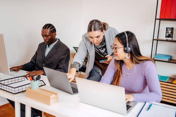 istock Small group of employees working together in front of computer 2185277739