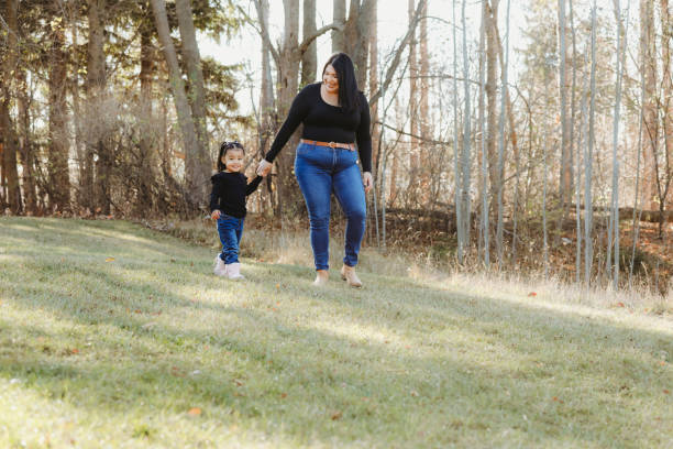 istock Little Girl and Mom on a Walk Outside 2185278497