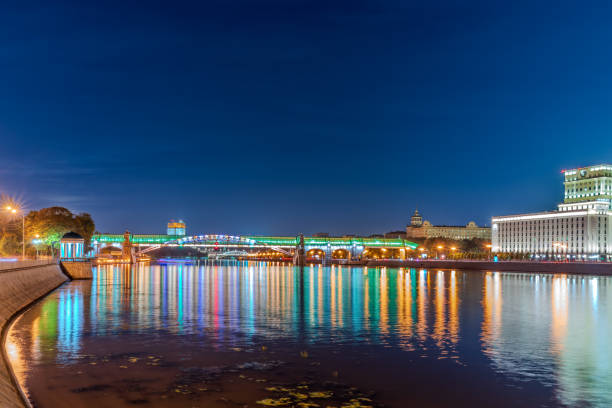 Pushkinskiy bridge with night illumination. Pedestrian bridge with night illumination. Bridge to Gorky Park. Embankment of the Moscow River