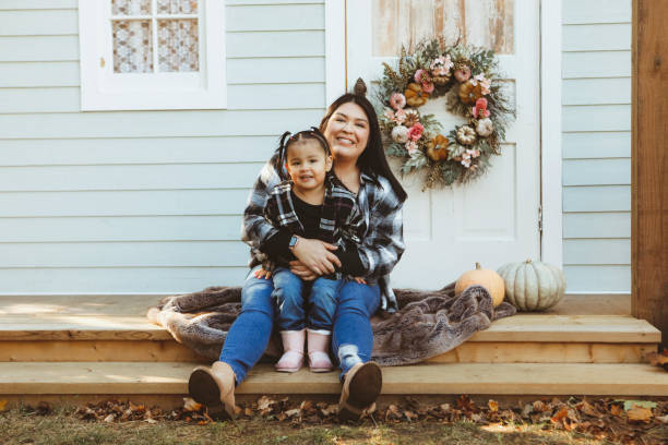 istock Little Girl and Mom on a Charming Rustic Porch 2185280598