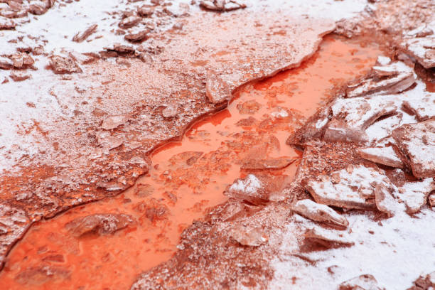 Red oxidized soils with puddles in winter
