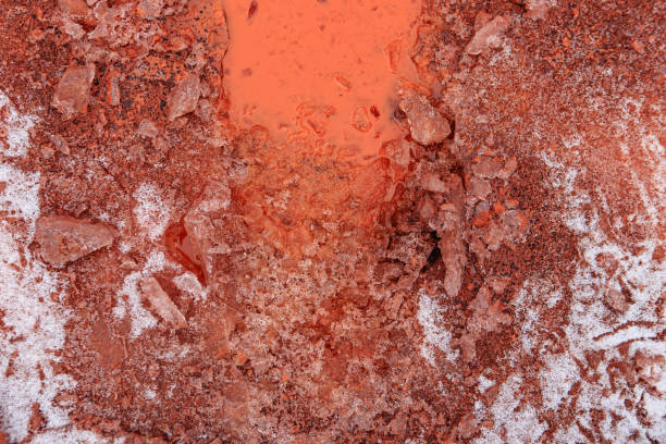 Red oxidized soils with puddles in winter