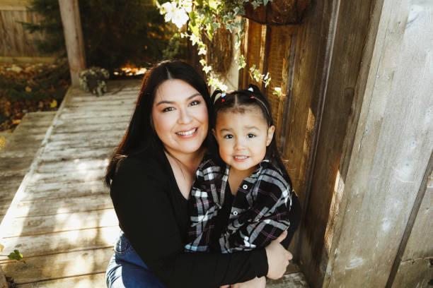 istock Little Girl and Mom on a Charming Rustic Porch 2185281707