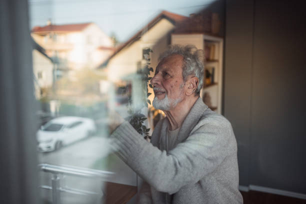 istock Grandpa chooses a book from his collection 2185283177