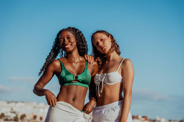 istock Two women are posing for a picture on a beach, multi ethnic group, carefree feeling 2185283622
