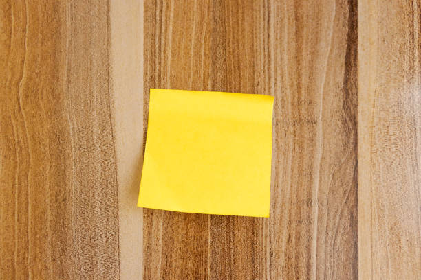 istock Small yellow notes without writing and pasted on wooden table background, Social media posts, design, stock images. 2185283634