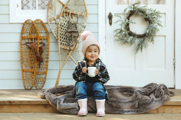 istock Little Girl on a Charming Rustic Porch with Hot Chocolate 2185287645