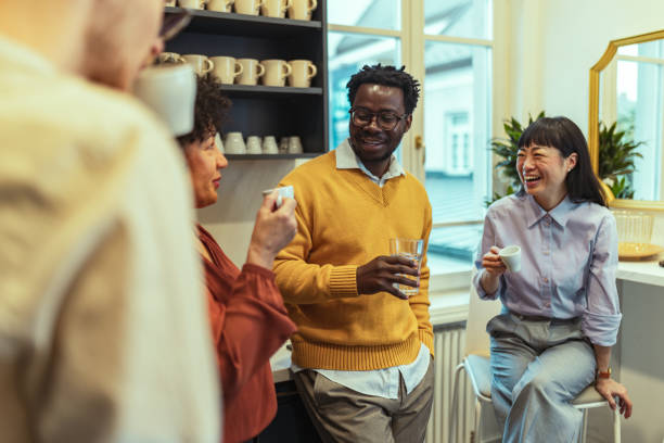 istock Multiracial group of business people drinking coffee in the kitchen and having fun while discussing their business careers 2185291229