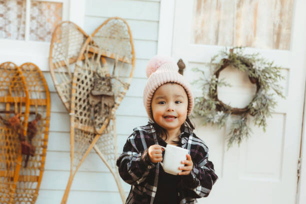 istock Little Girl on a Charming Rustic Porch with Hot Chocolate 2185291311